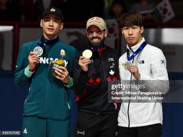 Shaolin Sandor Liu of Hungary , Charles Hamelin of Canada and Dae Heon Hwang of Korea hold up their medals after completing the men's 3000 meter...