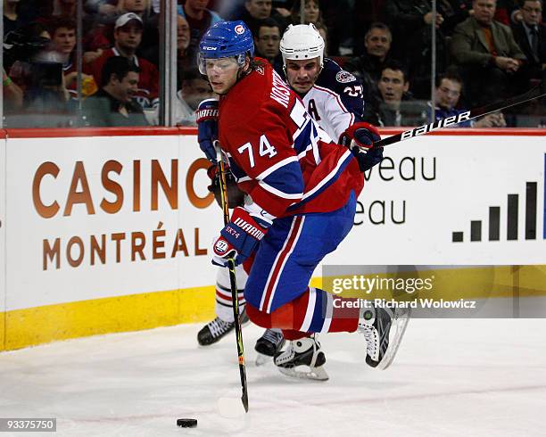 Sergei Kostitsyn of the Montreal Canadiens stick handles the puck while being defended by Rostislav Klesla of the Columbus Blue Jackets during the...