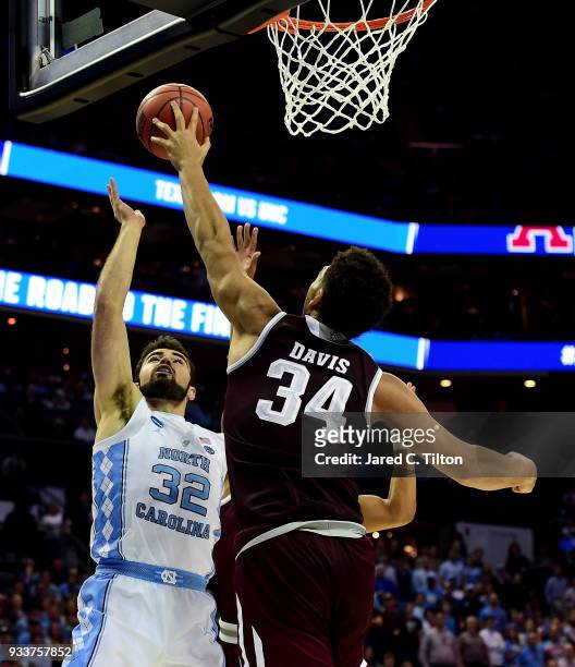 Tyler Davis of the Texas A&M Aggies blocks a shot by Luke Maye of the North Carolina Tar Heels during the second round of the 2018 NCAA Men's...