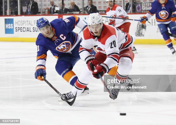 John Tavares of the New York Islanders checks Sebastian Aho of the Carolina Hurricanes during the second period at the Barclays Center on March 18,...
