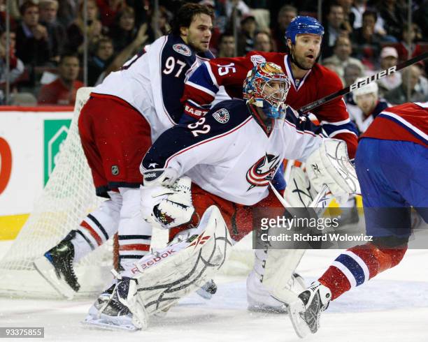 Mathieu Garon of the Columbus Blue Jackets is pushed out of the net by Glen Metropolit of the Montreal Canadiens and Rostislav Klesla of the Columbus...
