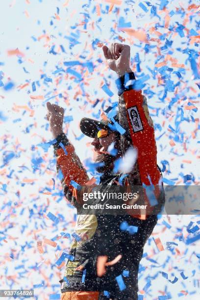 Martin Truex Jr., driver of the Bass Pro Shops/5-hour ENERGY Toyota, celebrates in victory lane after winning the Monster Energy NASCAR Cup Series...