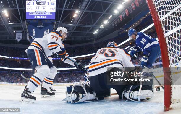 Miller of the Tampa Bay Lightning battles for the puck against Oscar Klefbom and goalie Al Montoya of the Edmonton Oilers during the second period at...