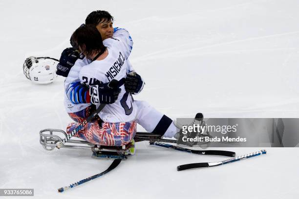 Rico Roman and Joshua Misiewicz of the United States celebrate winning the gold medal over Canada in the Ice Hockey gold medal game between United...