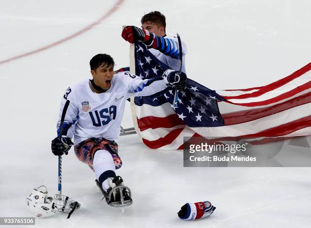 Rico Roman of the United States celebrates winning the gold medal over Canada in the Ice Hockey gold medal game between United States and Canada...
