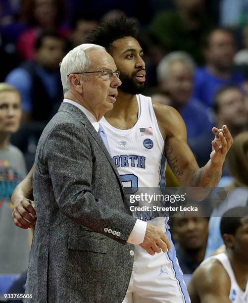 Joel Berry II of the North Carolina Tar Heels talks to head coach Roy Williams during a break against the Texas A&M Aggies in the second round of the...