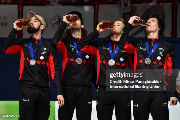 Members of Team Canada drink maple syrup after finishing third in the men's 5000 meter relay Final during the World Short Track Speed Skating...