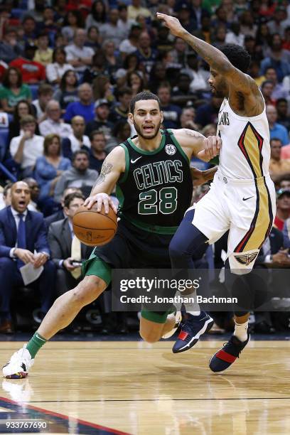 Abdel Nader of the Boston Celtics drives against Larry Drew II of the New Orleans Pelicans during the first half at the Smoothie King Center on March...