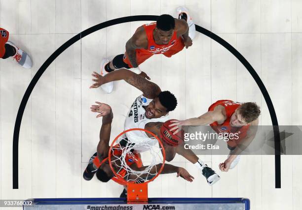 Nick Ward of the Michigan State Spartans drives to the basket against Marek Dolezaj of the Syracuse Orange in the second round of the 2018 NCAA Men's...