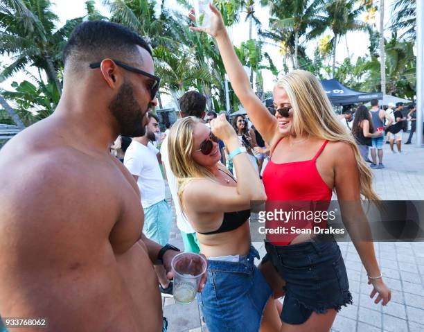 Students on Spring Break dance to DJ music during the launch pool party produced by 93.5FM Revolution Radio Miami at the Nationl Hotel on South Beach...