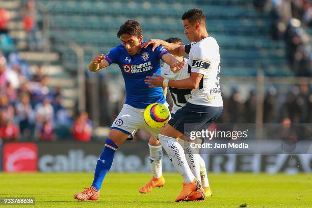 Angel Mena of Cruz Azul fights for the ball with Pablo Barrera of Pumas during the 12th round match between Cruz Azul and Pumas UNAM as part of the...