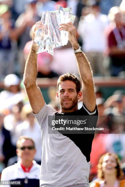 Juan Martin Del Potro of Argentina celebrates with the winner's trophy after defeating Roger Federer of Switzerland during the men's final on Day 14...