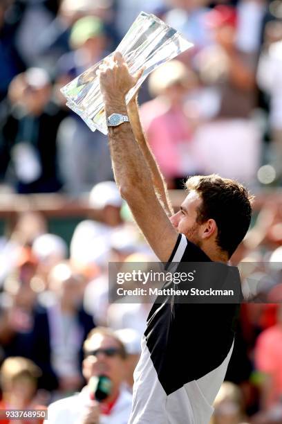 Juan Martin Del Potro of Argentina celebrates with the winner's trophy after defeating Roger Federer of Switzerland during the men's final on Day 14...