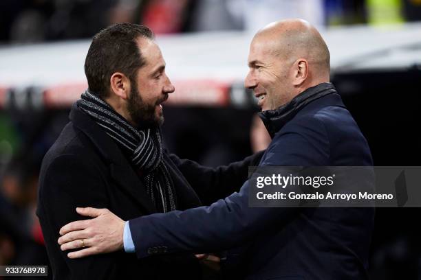 Head coach Zinedine Zidane of Real Madrid CF welcomes head coach Pablo Machin of Girona FC during the La Liga match between Real Madrid CF and Girona...