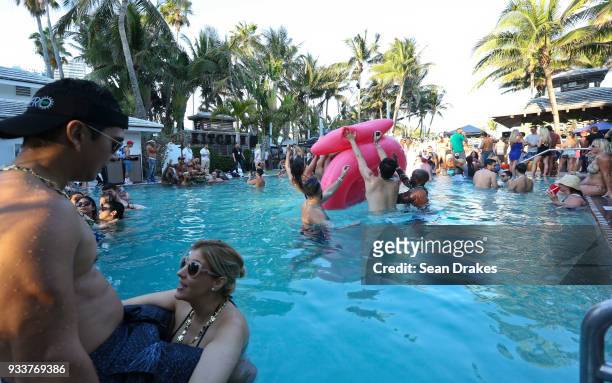 People dance to DJ music during the launch pool party produced by 93.5FM Revolution Radio Miami at the Nationl Hotel on South Beach as part of Miami...
