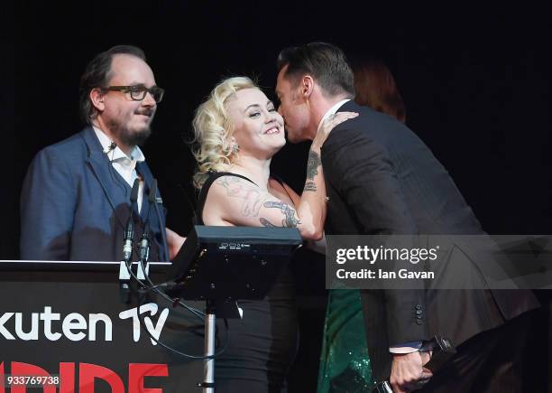 Associate Editor Chris Hewitt and Editor-in-Chief Terri White welcome actor Hugh Jackman, winner of the Best Actor award, on stage during the Rakuten...