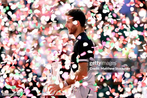 Juan Martin Del Potro of Argentina poses with the winner's trophy after defeating Roger Federer of Switzerland during the men's final on Day 14 of...