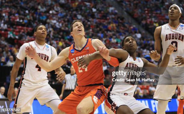 David Skara of the Clemson Tigers looks for a rebound against Davion Mitchell and Chuma Okeke of the Auburn Tigers in the first half during the...