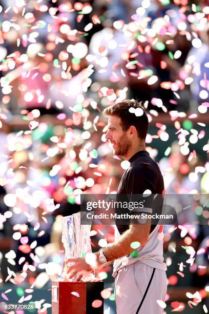 Juan Martin Del Potro of Argentina poses with the winner's trophy after defeating Roger Federer of Switzerland during the men's final on Day 14 of...