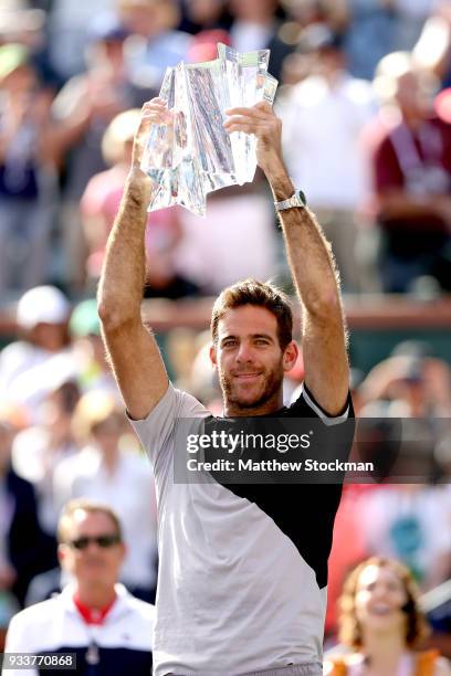 Juan Martin Del Potro of Argentina celebrates with the winner's trophy after defeating Roger Federer of Switzerland during the men's final on Day 14...