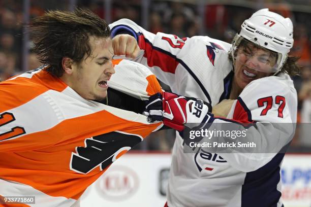 Oshie of the Washington Capitals and Travis Konecny of the Philadelphia Flyers fight during the third period at Wells Fargo Center on March 18, 2018...