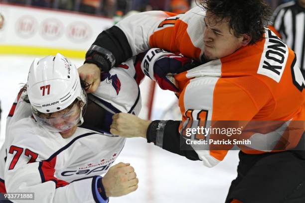 Oshie of the Washington Capitals and Travis Konecny of the Philadelphia Flyers fight during the third period at Wells Fargo Center on March 18, 2018...