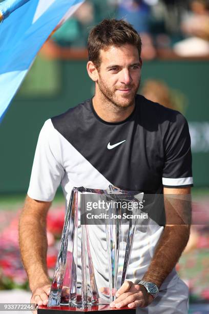 Juan Martin Del Potro of Argentina holds the winner's trophy after beating Roger Federer of Switzerland in three sets at the BNP Paribas Open on...