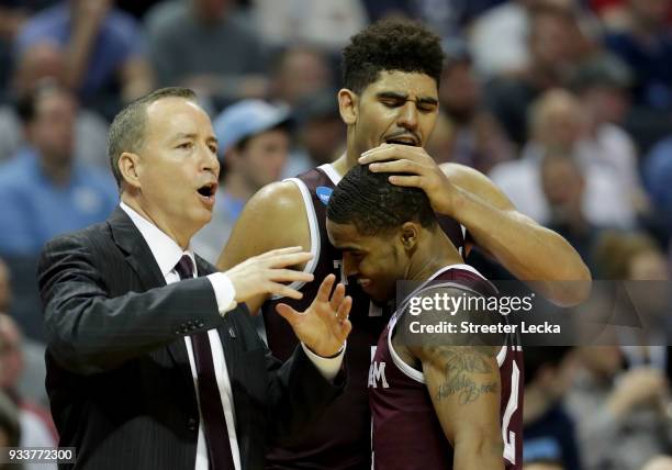 Head coach Billy Kennedy, Tyler Davis, and TJ Starks of the Texas A&M Aggies react after defeating the North Carolina Tar Heels 86-65 during the...