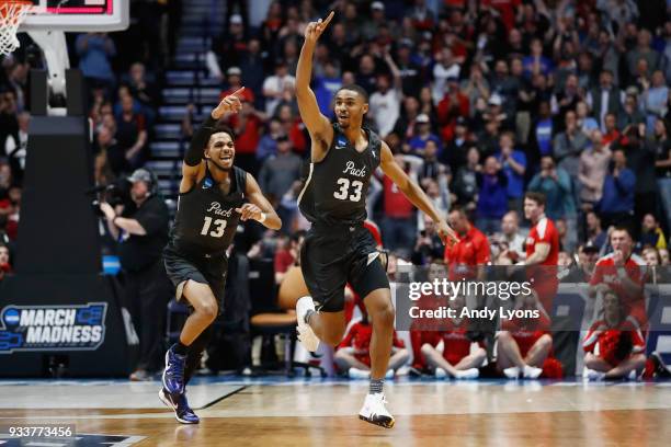 Josh Hall of the Nevada Wolf Pack celebrates with Hallice Cooke after defeating the Cincinnati Bearcats during the second half in the second round of...