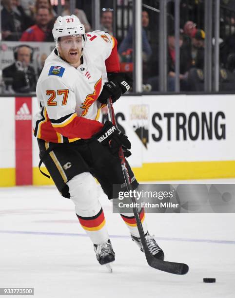 Dougie Hamilton of the Calgary Flames skates with the puck against the Vegas Golden Knights in the third period of their game at T-Mobile Arena on...