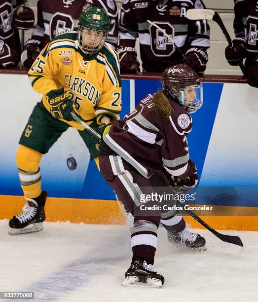 Rhyen McGill of Clarkson University and Olivia Zafuto of Colgate University fought for the puck during the Division I Women's Ice Hockey Championship...