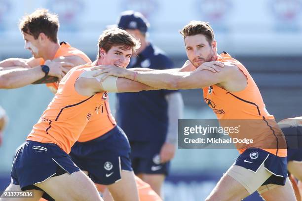 Paddy Dow of the Blues and Dale Thomas keep a watchful eye on the media during a Carlton Blues AFL training session at Ikon Park on March 19, 2018 in...