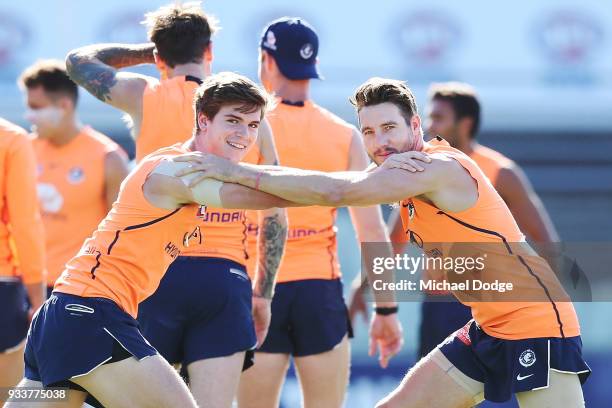 Paddy Dow of the Blues and Dale Thomas keep a watchful eye on the media during a Carlton Blues AFL training session at Ikon Park on March 19, 2018 in...