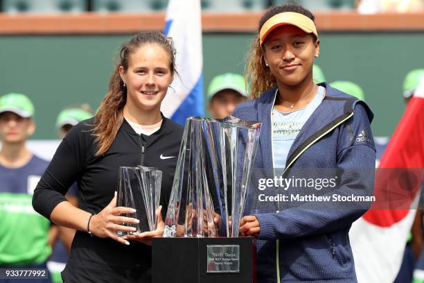 Daria Kasatkina of Russia and Naomi Osaka of Japan pose at the trophy ceremony during the women's final on Day 14 of the BNP Paribas Open at the...