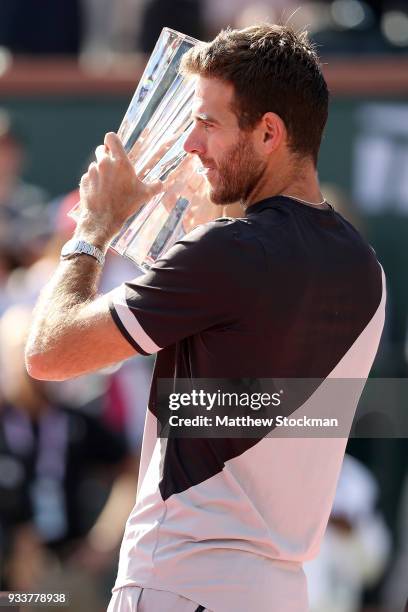 Juan Martin Del Potro of Argentina poses with the winner's trophy after defeating Roger Federer of Switzerland during the men's final on Day 14 of...