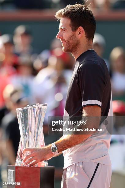 Juan Martin Del Potro of Argentina poses with the winner's trophy after defeating Roger Federer of Switzerland during the men's final on Day 14 of...