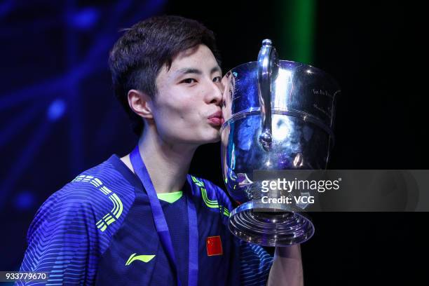 Shi Yuqi of China poses with his trophy after winning the Men's singles final match against Lin Dan of China on day five of the YONEX All England...