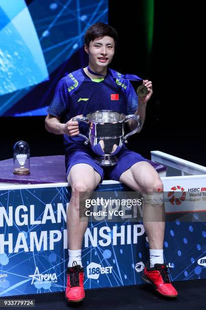 Shi Yuqi of China poses with his trophy after winning the Men's singles final match against Lin Dan of China on day five of the YONEX All England...