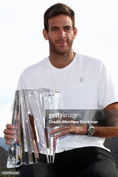 Juan Martin Del Potro of Argentina poses with the winner's trophy after defeating Roger Federer of Switzerland during the men's final on Day 14 of...