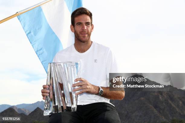 Juan Martin Del Potro of Argentina poses with the winner's trophy after defeating Roger Federer of Switzerland during the men's final on Day 14 of...