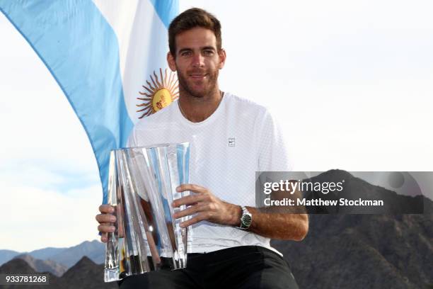 Juan Martin Del Potro of Argentina poses with the winner's trophy after defeating Roger Federer of Switzerland during the men's final on Day 14 of...