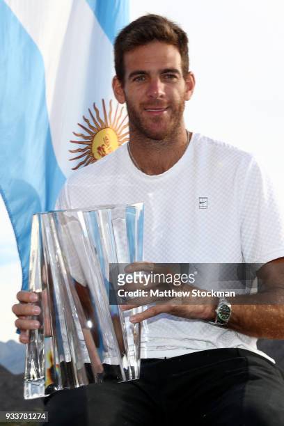 Juan Martin Del Potro of Argentina poses with the winner's trophy after defeating Roger Federer of Switzerland during the men's final on Day 14 of...