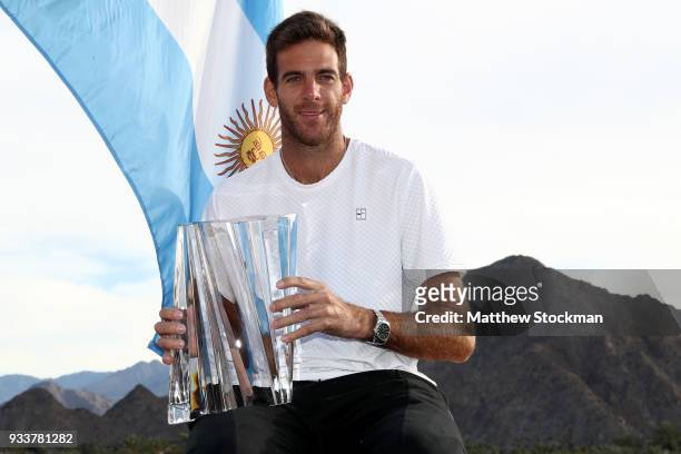 Juan Martin Del Potro of Argentina poses with the winner's trophy after defeating Roger Federer of Switzerland during the men's final on Day 14 of...