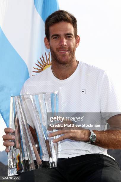 Juan Martin Del Potro of Argentina poses with the winner's trophy after defeating Roger Federer of Switzerland during the men's final on Day 14 of...