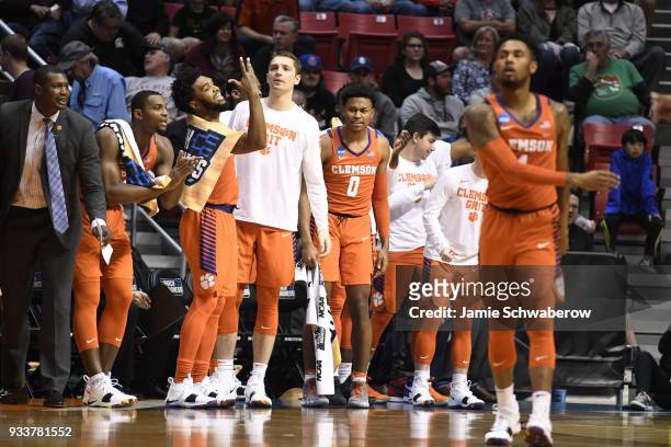 Clyde Trapp of the Clemson Tigers and the bench cheer on their team against the Auburn Tigers in the second round of the 2018 NCAA Photos via Getty...