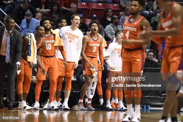 Clyde Trapp of the Clemson Tigers and the bench cheer on their team against the Auburn Tigers in the second round of the 2018 NCAA Photos via Getty...