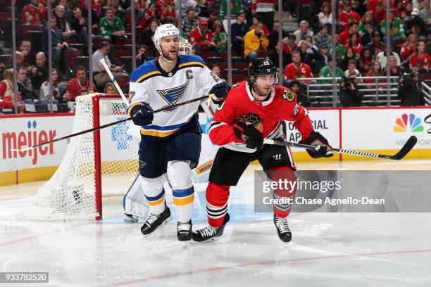 Alex Pietrangelo of the St. Louis Blues and Brandon Saad of the Chicago Blackhawks watch for the puck in the second period at the United Center on...