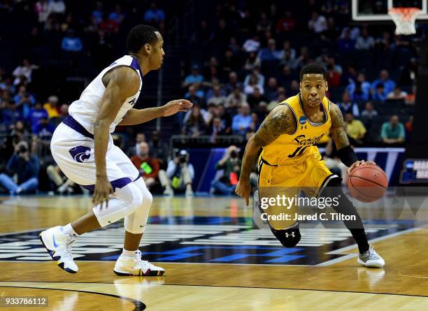 Jairus Lyles of the UMBC Retrievers drives to the basket against Barry Brown of the Kansas State Wildcats during the second round of the 2018 NCAA...