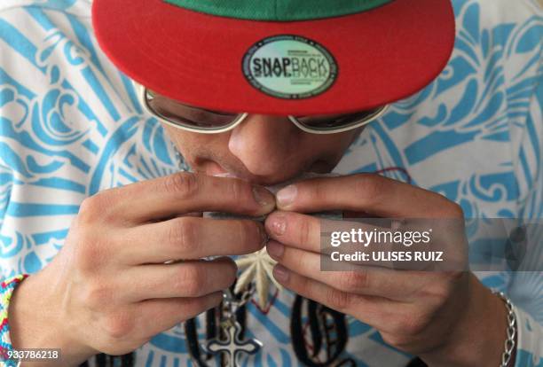 Man rolls a joint during the first Cannabis Cup where self-cultivation and the quality of the herb are encouraged, in Tlajomulco de Zuniga, Jalisco...