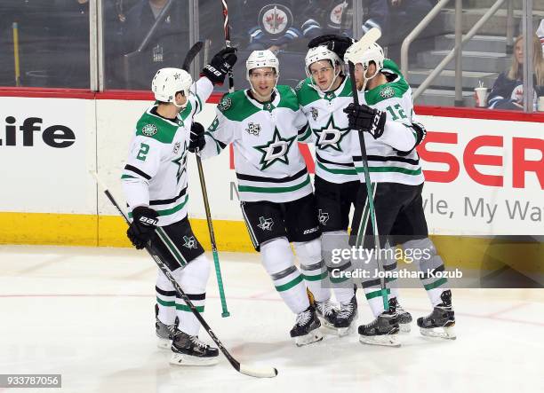 Dan Hamhuis, Tyler Pitlick, Mattias Janmark and Radek Faksa of the Dallas Stars celebrate a second period goal against the Winnipeg Jets at the Bell...